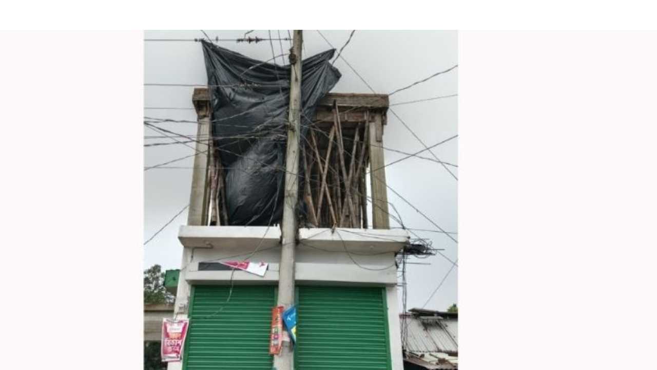 Building roof being cast while 11,000-volt electric poles are in place