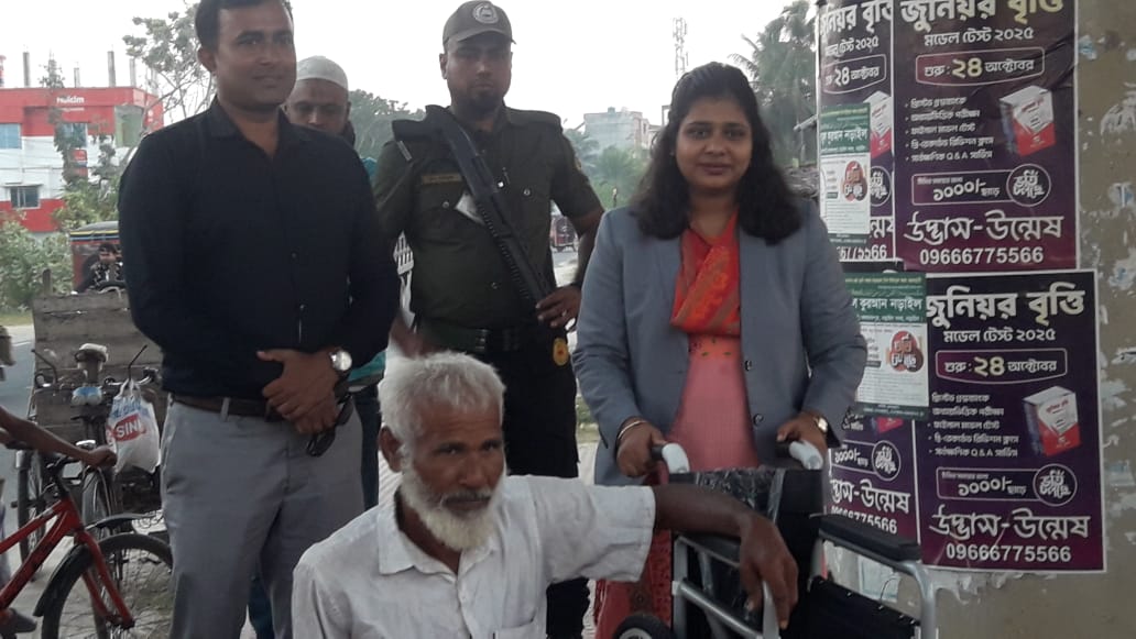 Upazila Executive Officer (UEO) next to Mofiz Uddin with special needs in Narail